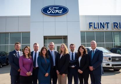 The Flint River Ford team standing in front of the dealership